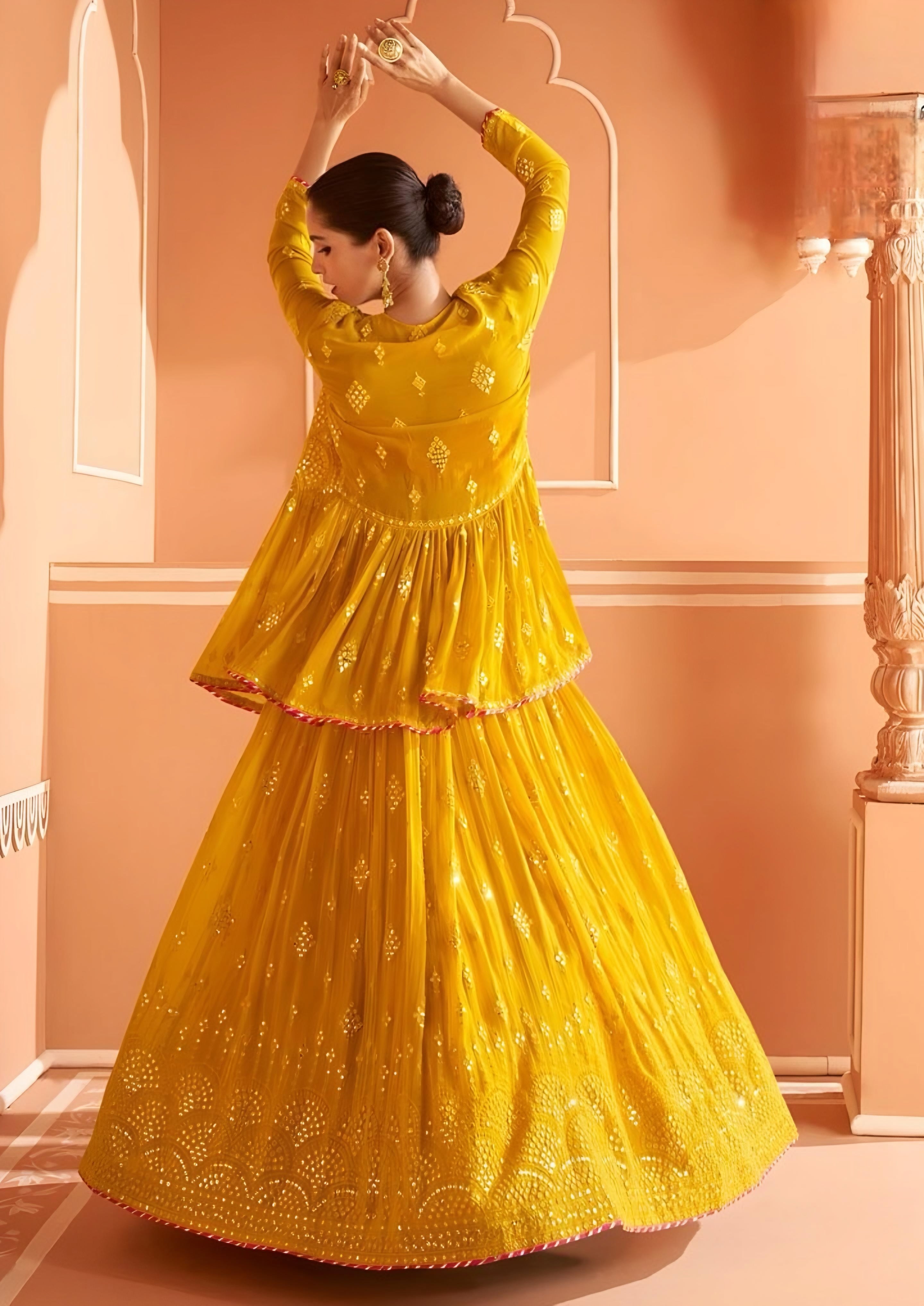 Full-length mustard yellow embroidered lehenga choli with flared skirt