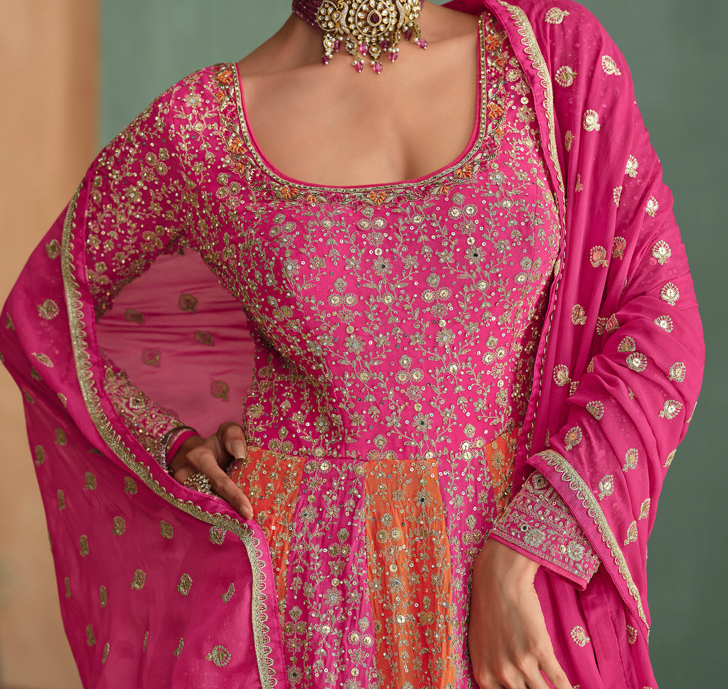 Pink embroidered traditional outfit with gold detailing on a blurred background