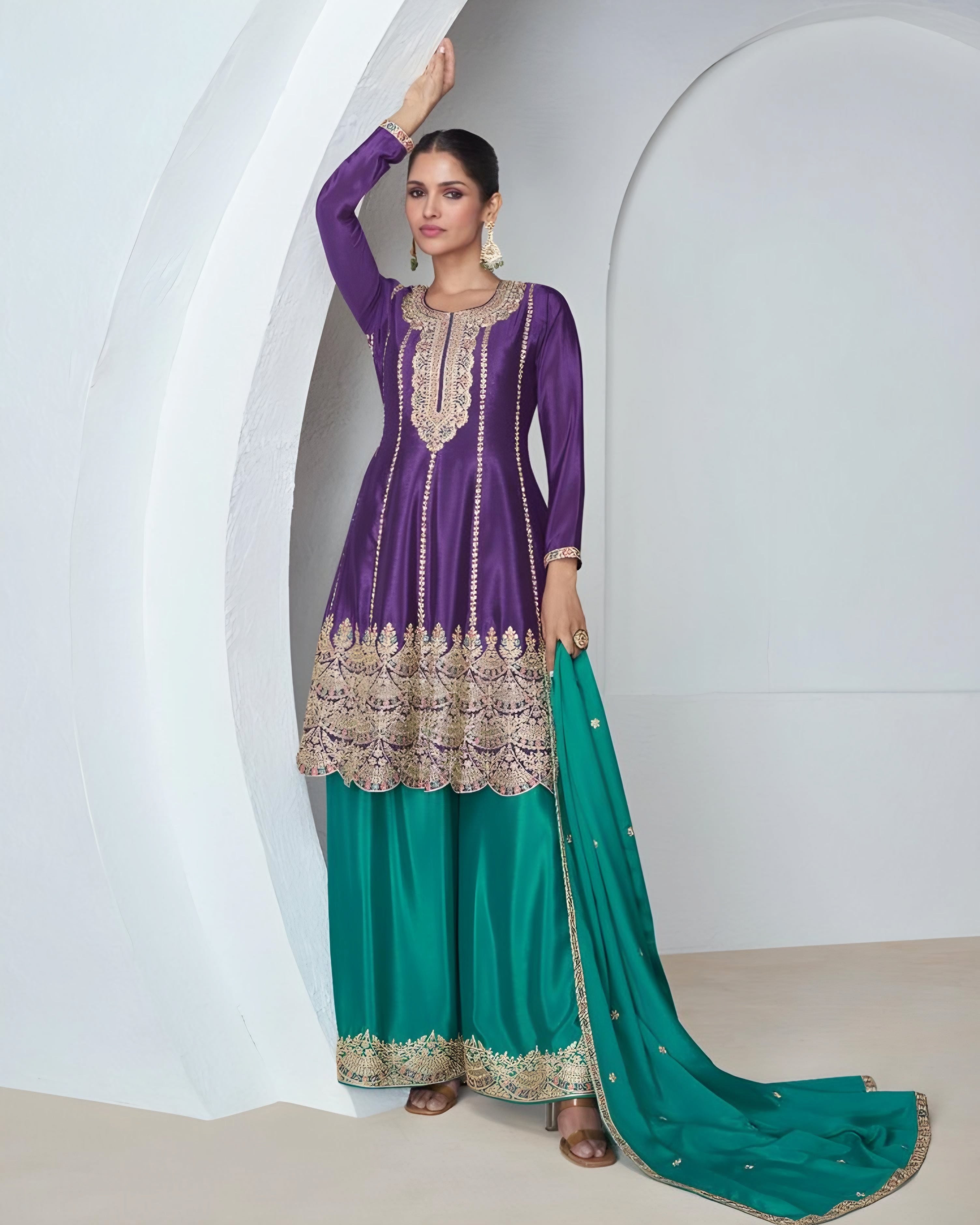 A woman modeling a vibrant violet Premium Chinon Silk Salwar Suit with embroidery work, paired with a matching dupatta.