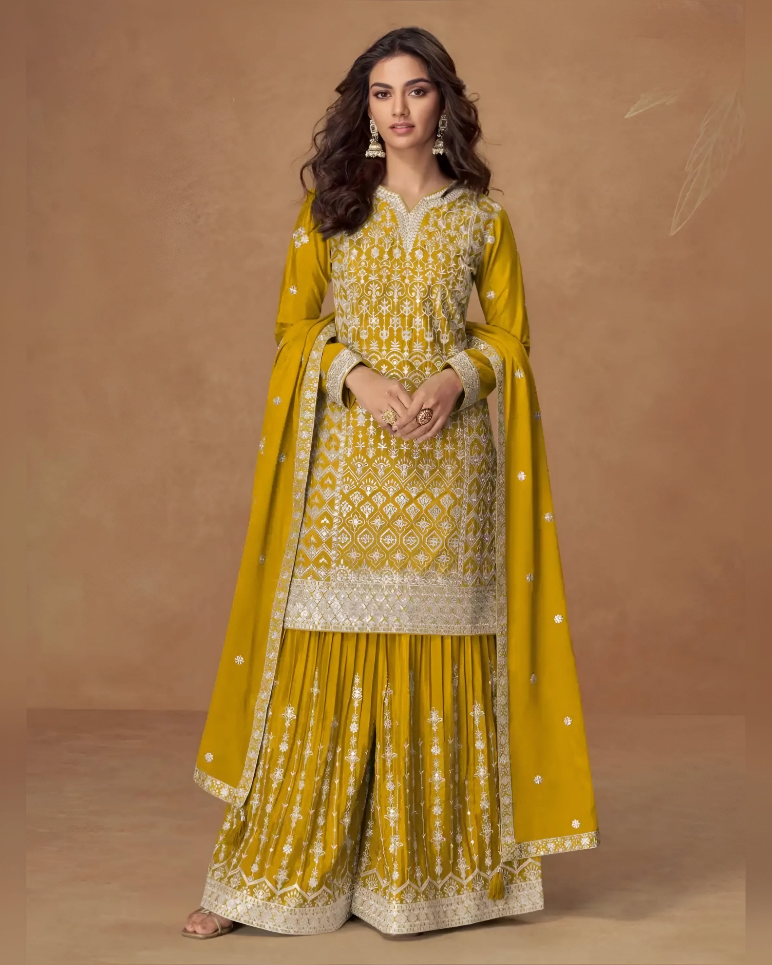 Woman wearing a yellow and white traditional outfit with a brown background