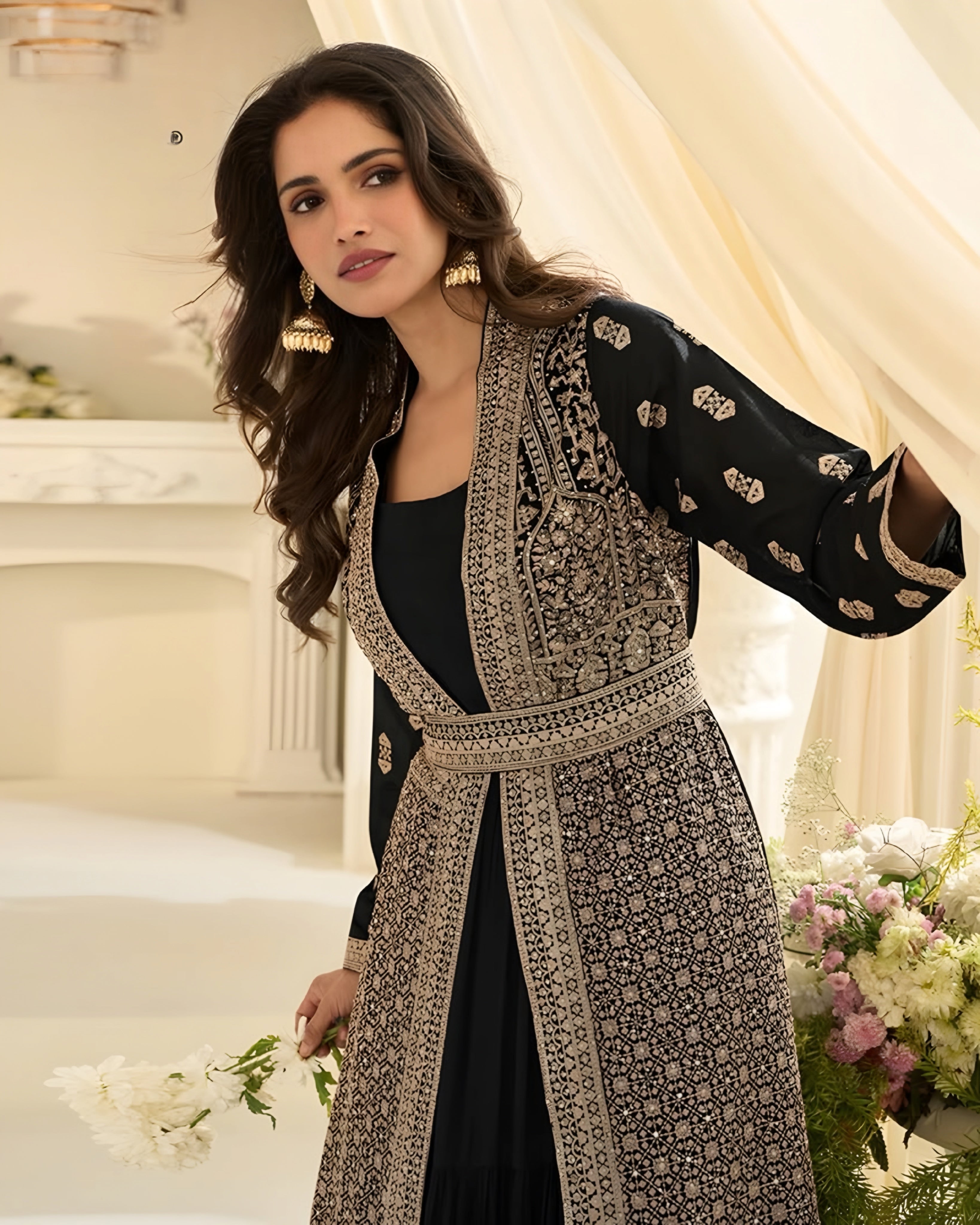 Woman wearing a patterned coat in an elegant indoor setting