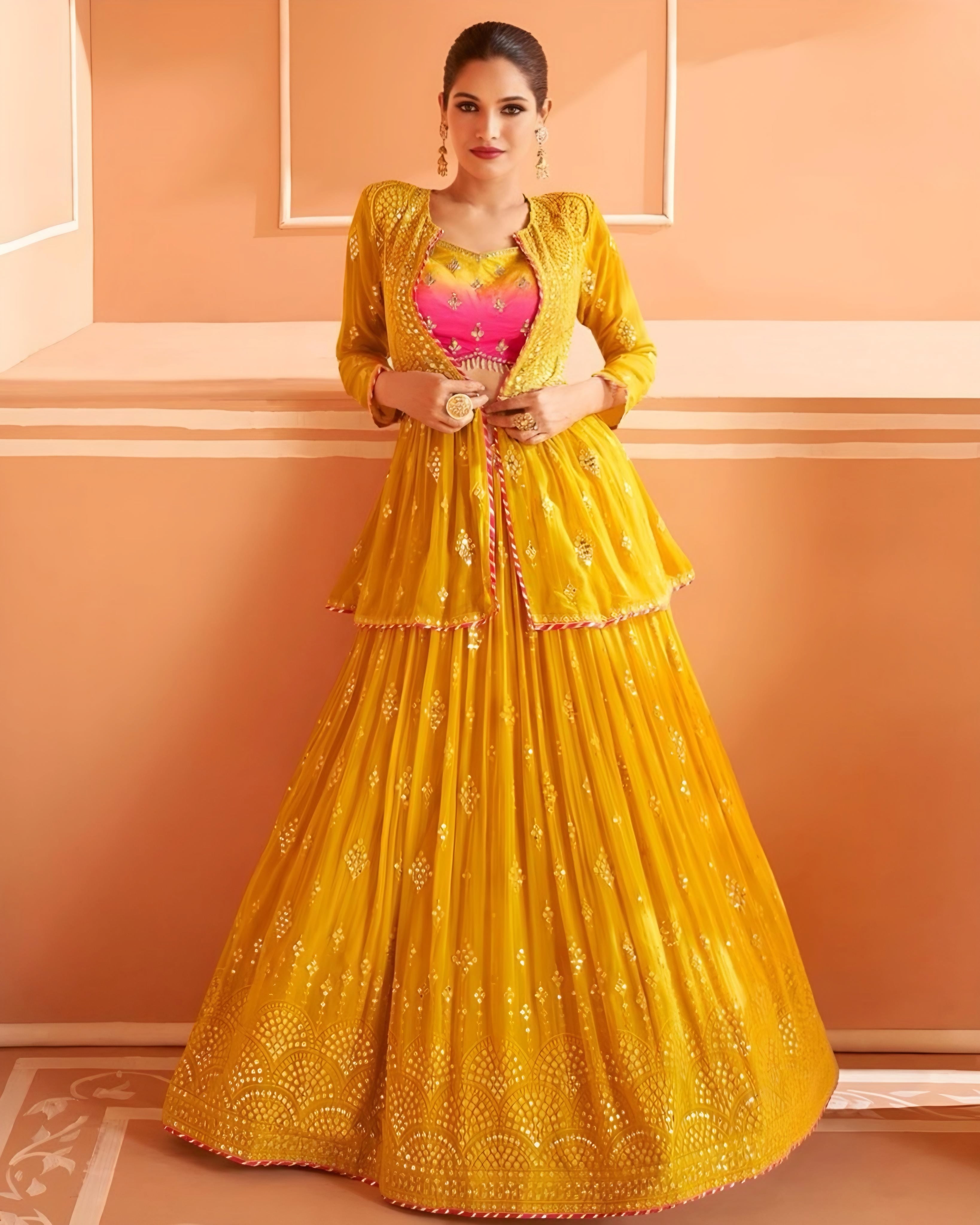 A woman wearing a yellow embroidered Indo Western lehenga with a designer blouse and a dupatta.